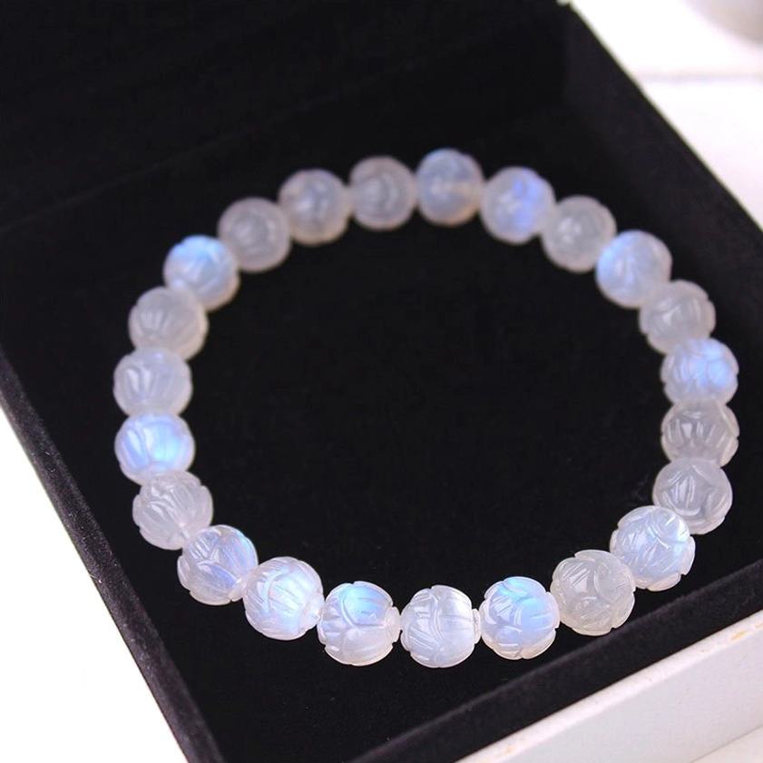 Moonstone lotus love bracelet close-up showing natural adularescence and handcrafted bead carving details