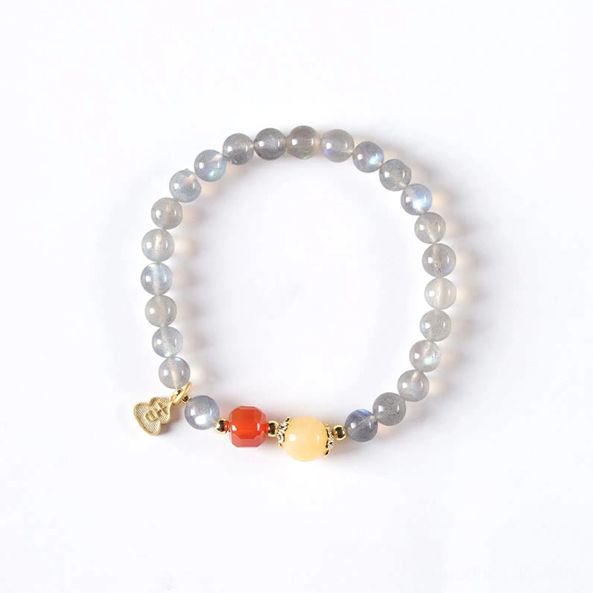 Buddhist moonstone red agate bracelet close-up showing red agate bead texture and natural stone characteristics with lotus charm