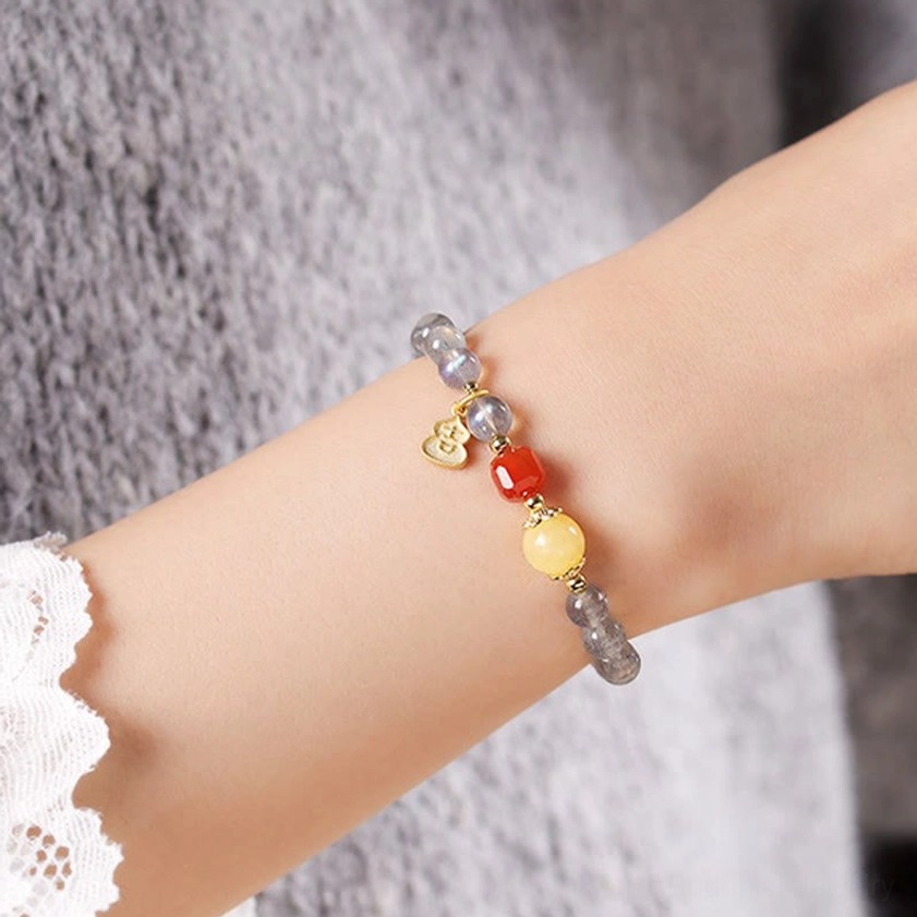 Moonstone South Red Agate variant bracelet worn on wrist demonstrating comfort fit and color appearance in natural light