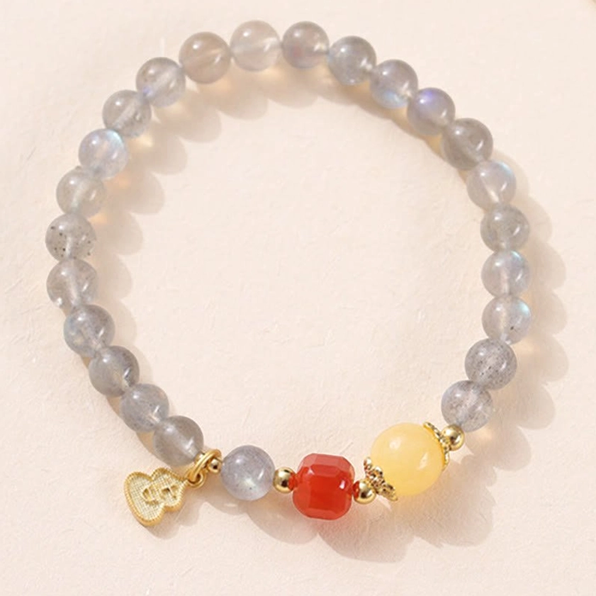 Moonstone South Red Agate bracelet variant flat lay showing red agate stone beads with moonstone and lotus charm details