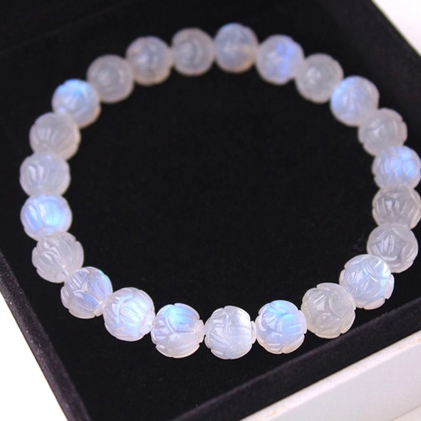Moonstone round beads bracelet top-down view with prominent blue iridescence, milky base color, natural gemstone