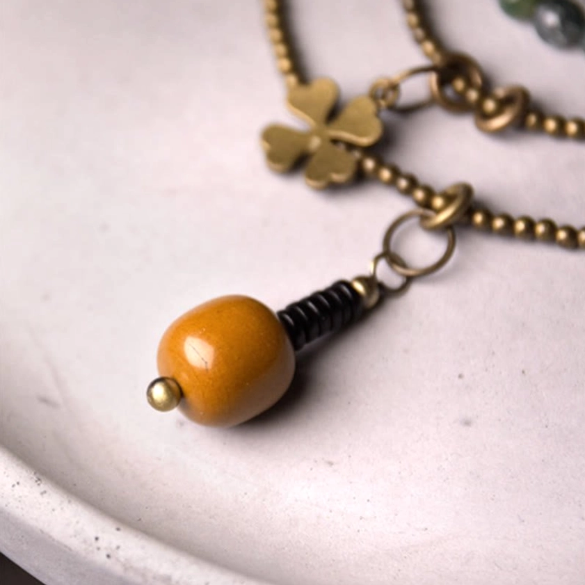 Brass clover charm and wrapped wooden pendant components for moss agate healing bracelet