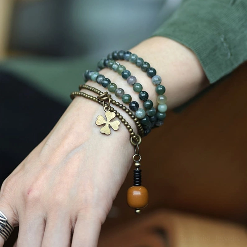 Moss agate copper healing bracelet worn on wrist with brass clover charm and wooden pendant - Buddhist spiritual jewelry