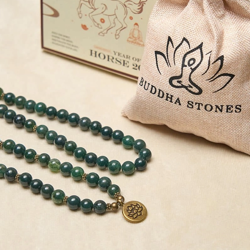 Moss agate Buddhist prayer mala with branded Buddha Stones linen pouch and product packaging, flat lay product display with gold lotus charm