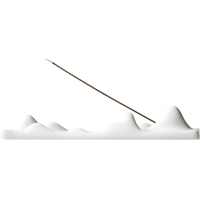 Off-white ceramic mountain peak incense holder with inserted incense stick releasing fragrance