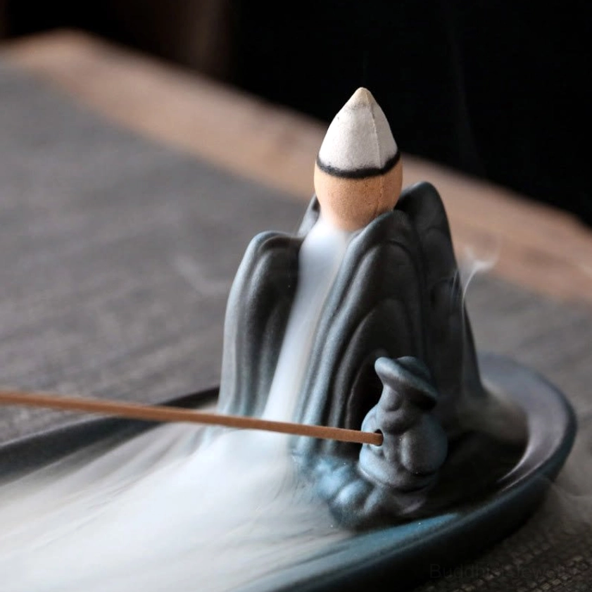 Mountain ceramic incense burner high side view with flowing backflow incense smoke