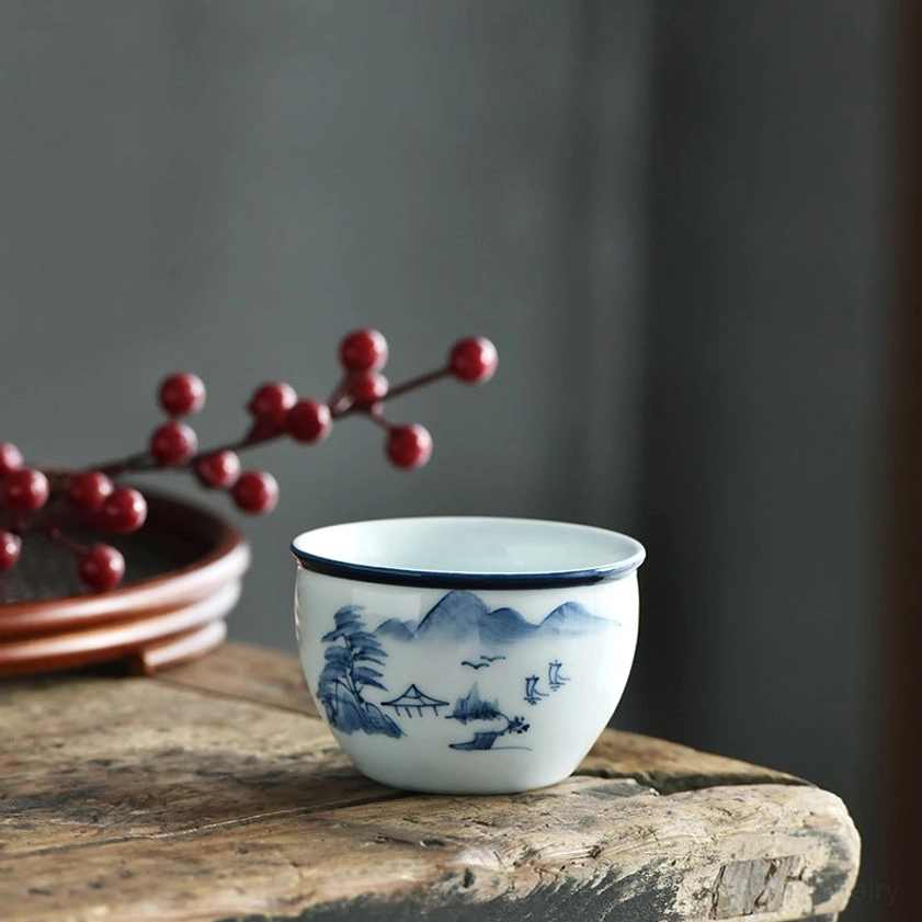 Mountain landscape painting ceramic tea cup, blue-and-white porcelain Buddhist inspired design
