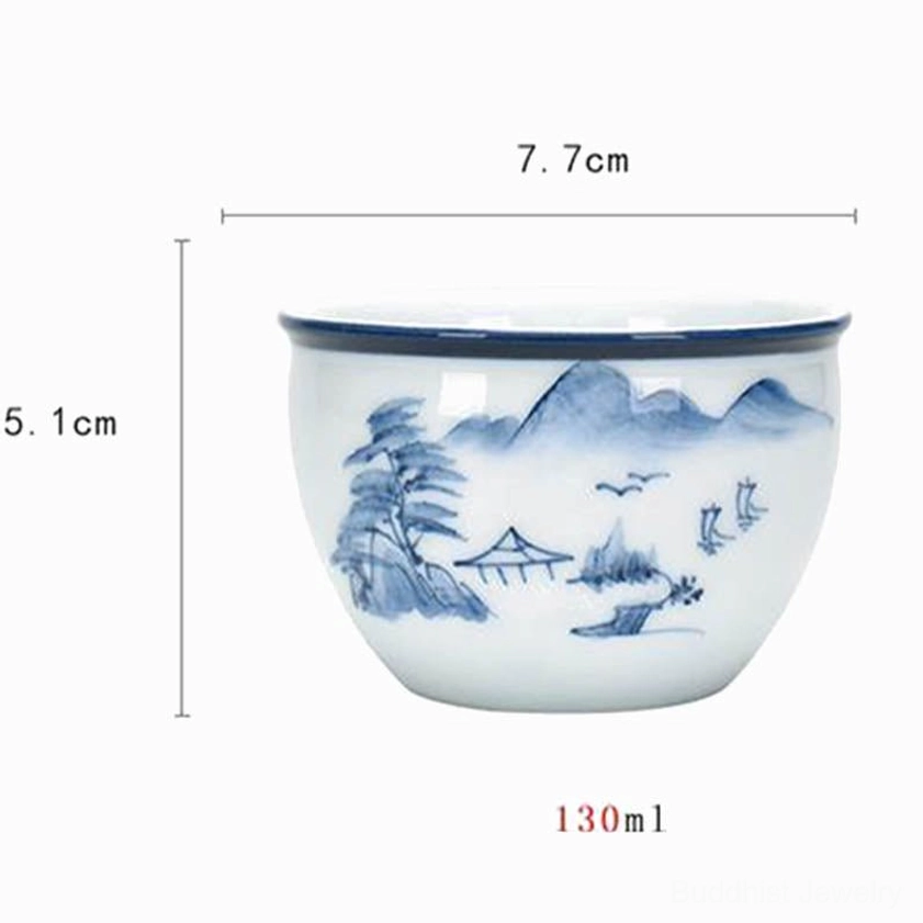 Buddhist inspired ceramic teacup with mountain and traditional house landscape motif