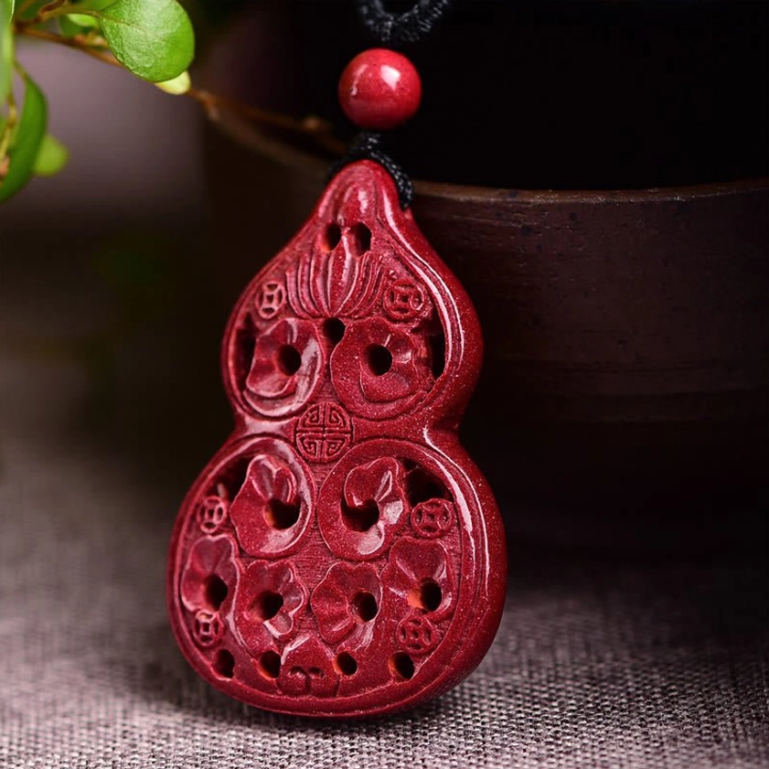Cinnabar Buddhist necklace pendant showing multi-symbol design with laughing Buddha yin yang and zodiac elements