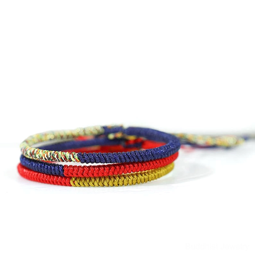 Buddhist red string protection bracelet with multicolor woven design and gold thread accents