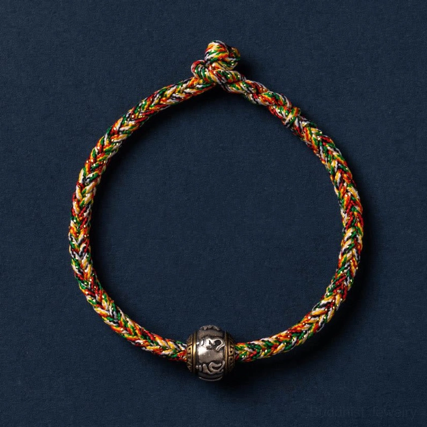Multicolored Buddhist braided bracelet featuring harmonious color blend, silver Om Mani Padme Hum bead, and slip-knot design