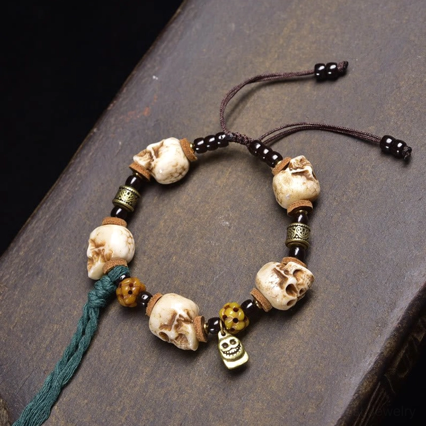 Multi-skull Tibetan prayer bracelet with metal spacers and teal tassel