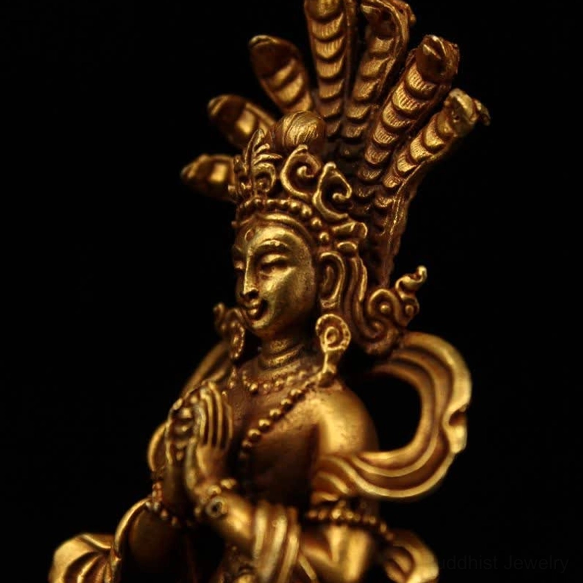 Right side close-up of Nagarjuna Bodhisattva showing prayer mudra hands, ear ornaments and shoulder accessories