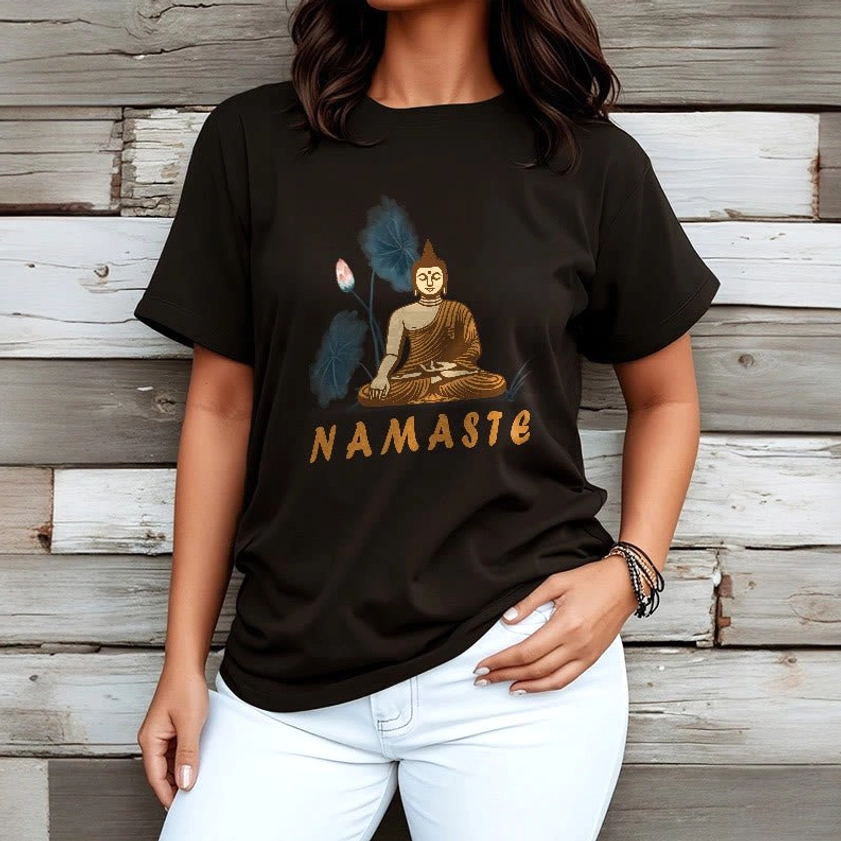 Female model in soft black Namaste Buddha Lotus T-Shirt with white pants on wooden background for conscious fashion