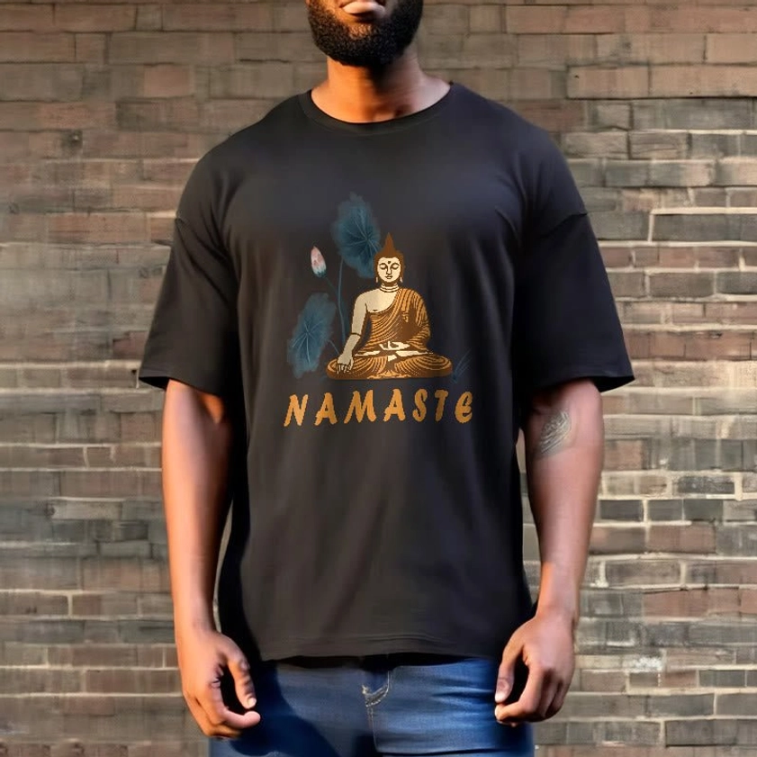 Male model wearing charcoal black Namaste Buddha Lotus T-Shirt against brown brick wall showing relaxed fit