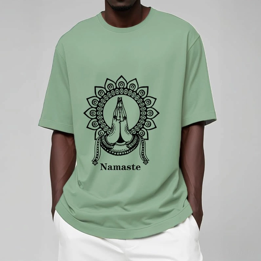 Male model wearing light cyan Namaste mandala Buddhist t-shirt on neutral studio background