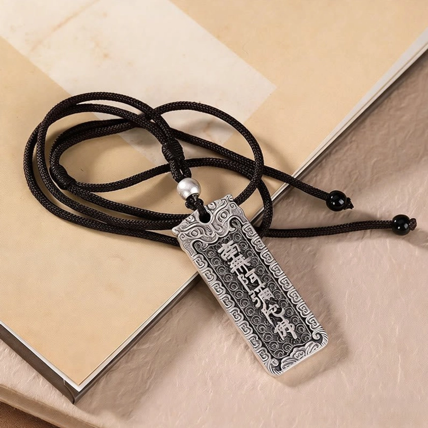 Namo Amitabha Buddha mantra copper pendant necklace with antique silver finish on vintage parchment and books