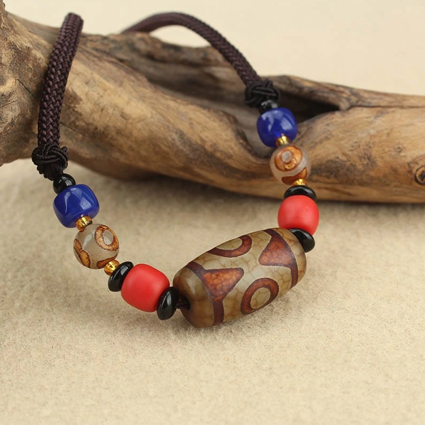 Natural agate dzi bead necklace showing authentic handmade quality with color variations and unique patterns
