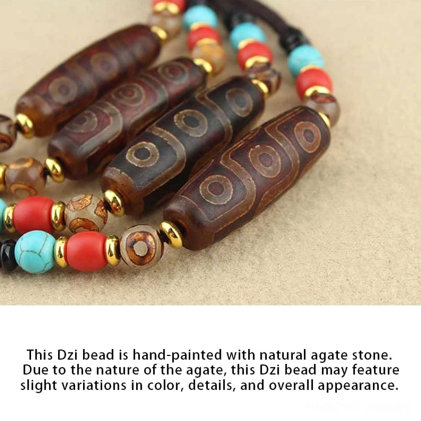 Multiple natural agate dzi bead pendants with golden metal accents and colorful stone spacers on light background showing handmade quality