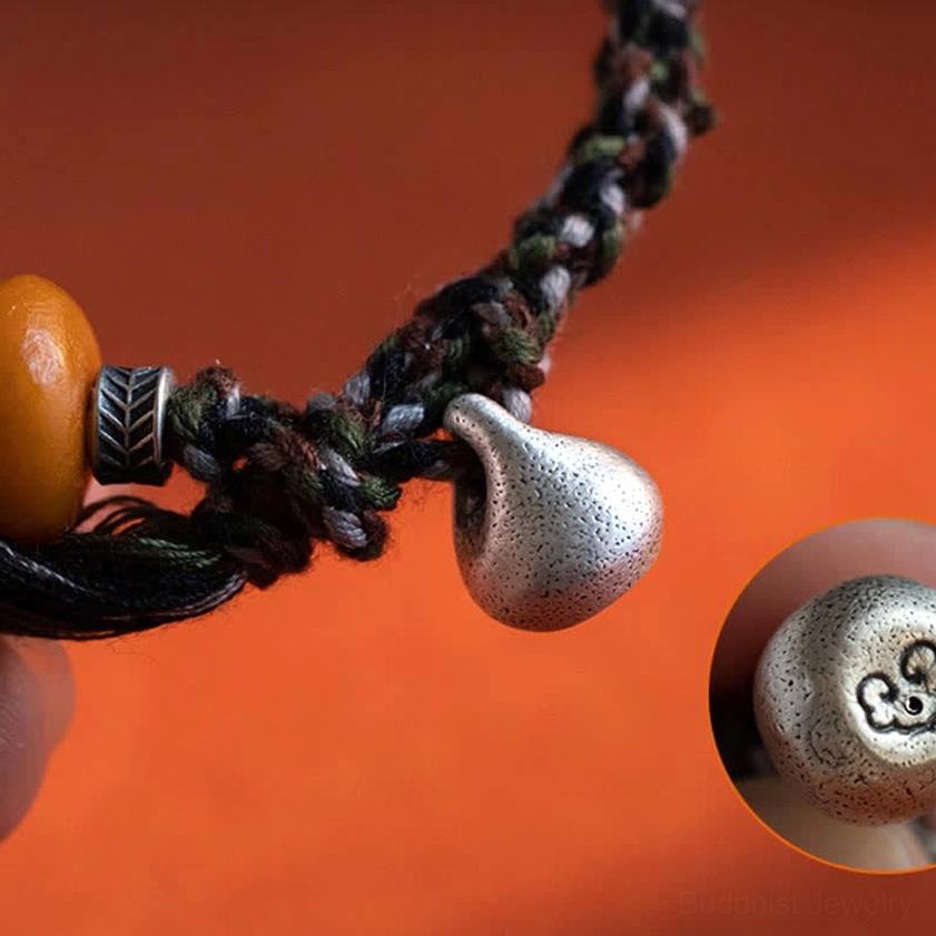 Genuine amber bead on handmade Buddhist protection bracelet with spiritual significance