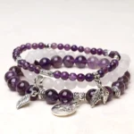 Handcrafted multi-layer healing crystal bracelet with natural amethyst, black obsidian and white quartz beads featuring silver lotus charm pendant - top view