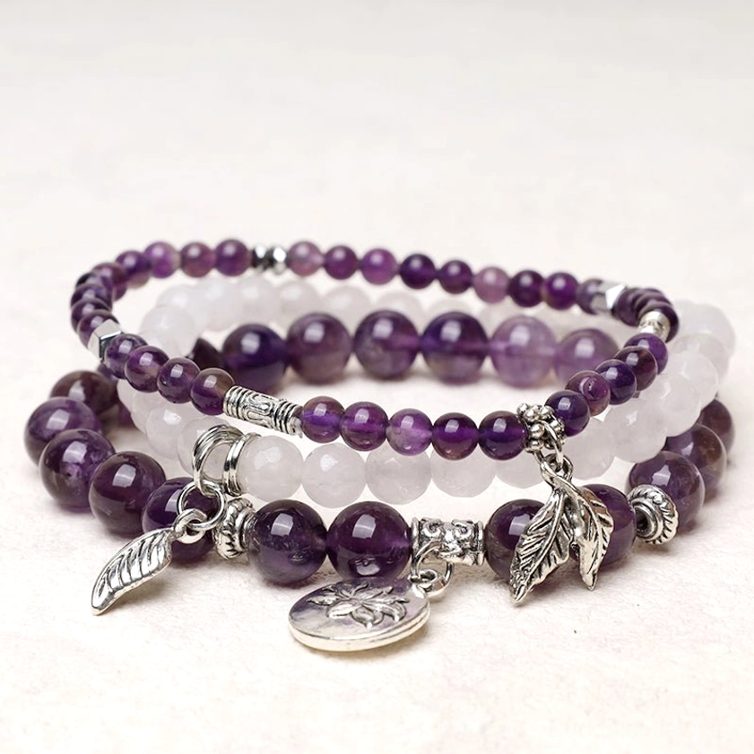 Handcrafted multi-layer healing crystal bracelet with natural amethyst, black obsidian and white quartz beads featuring silver lotus charm pendant - top view