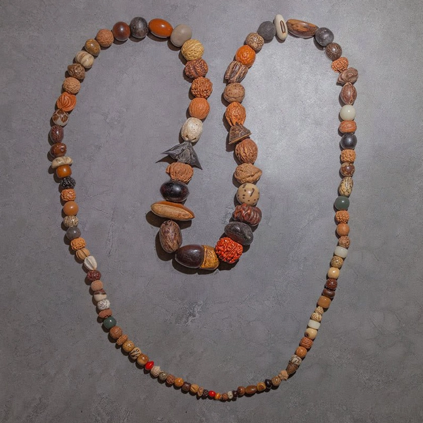 Natural bodhi seed prayer mala pair with diverse textured seeds dark wood spacers and woven cord for Buddhist practice