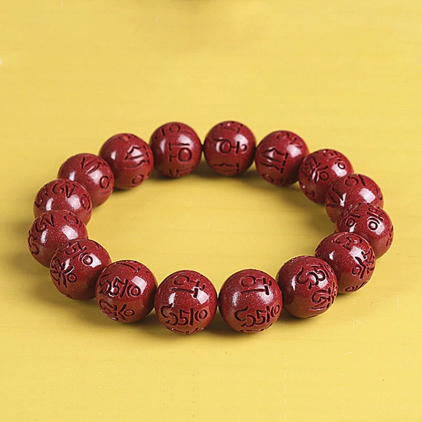 Natural cinnabar bracelet with Pixiu charm detail showing handcrafted quality