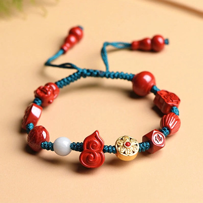 Cinnabar Om Mani Padme Hum bracelet with teal cord, gourd charm, red carved beads, and adjustable tassel detail