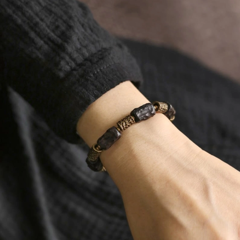 Natural ebony wood copper Buddhist bracelet showing authentic material texture