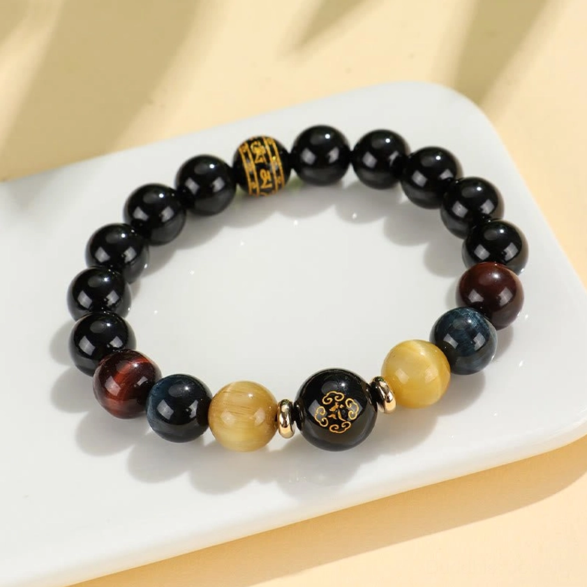 Close-up texture of natural black onyx and tiger eye gemstone beads showing authentic stone characteristics