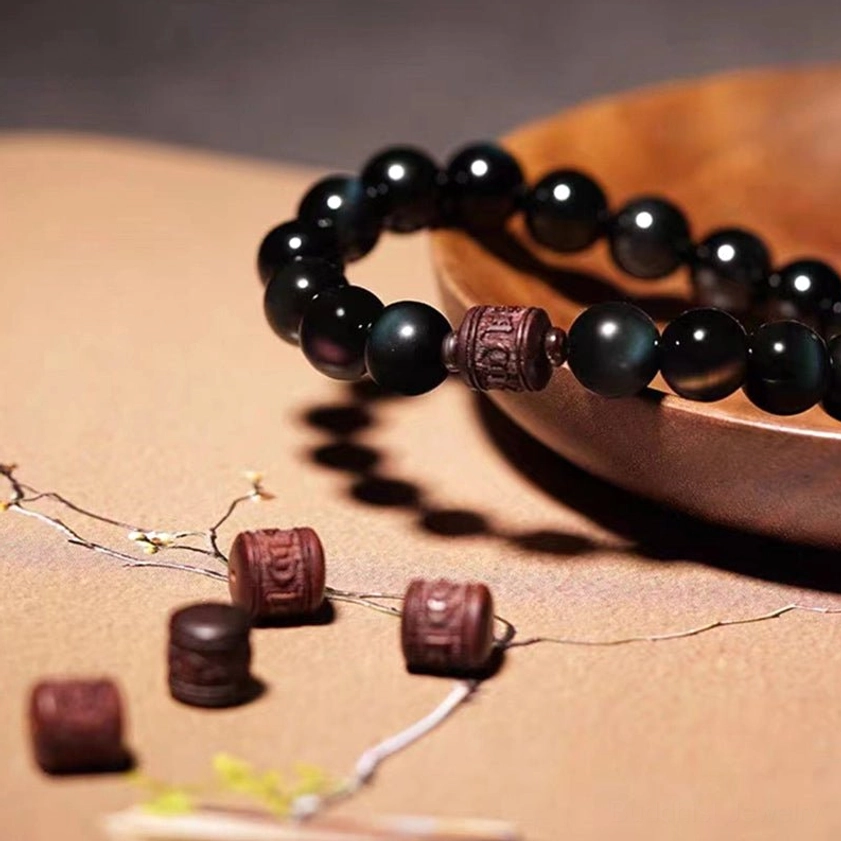 Natural obsidian gemstone bracelet with multiple spiritual engravings and red sandalwood spacers for holistic healing