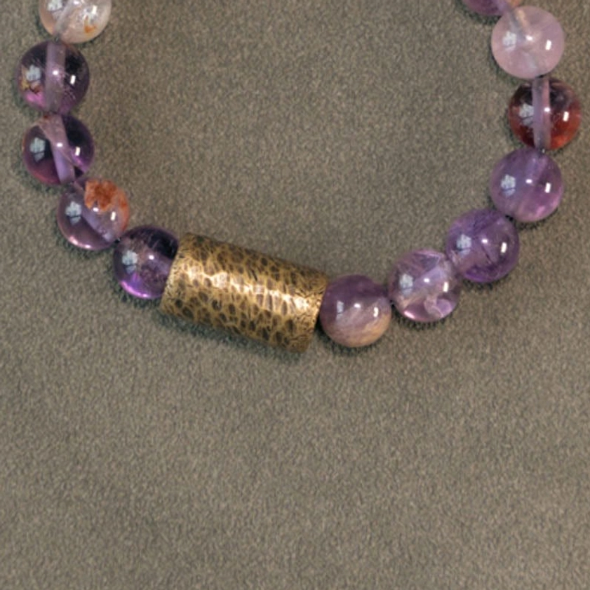 Natural quartz crystal cluster with protection bracelet showing energy connection