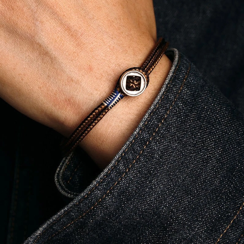 Natural rope and sterling silver Buddhist bracelet combining eco-friendly materials with ancient spiritual symbolism