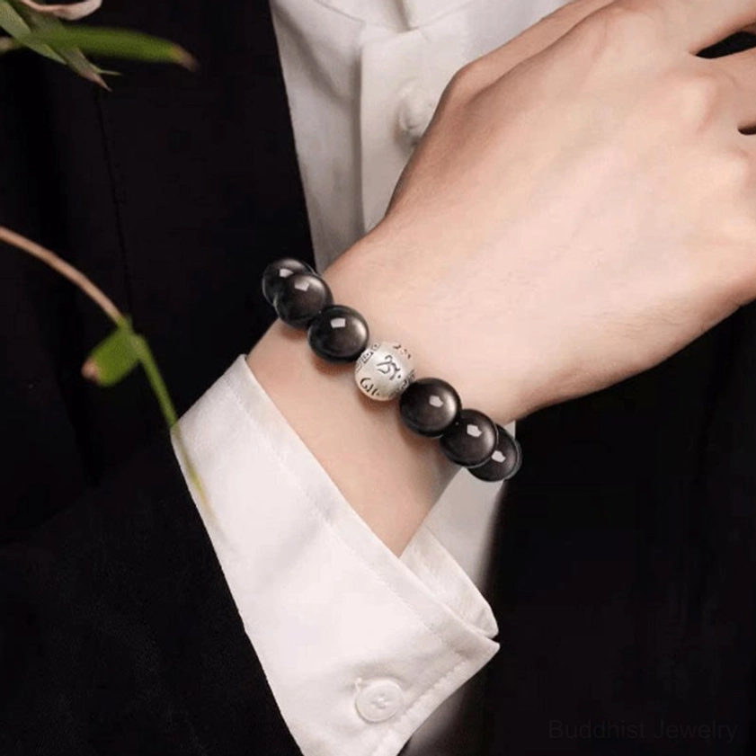 Natural Silver Sheen Obsidian bracelet with Om Mani Padme Hum mantra showing authentic stone variations and handmade quality