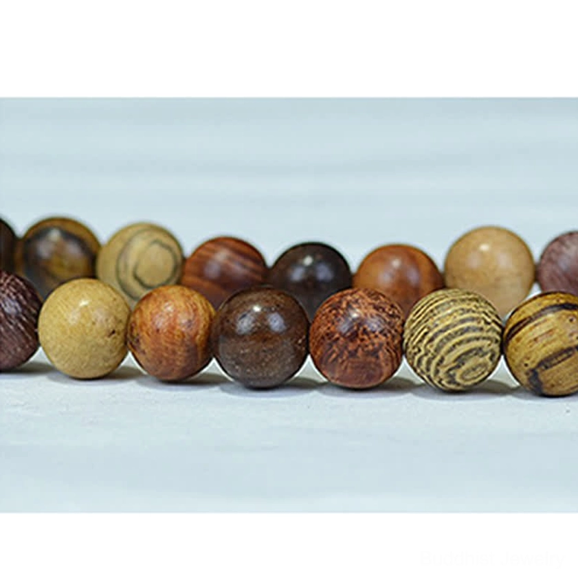 Assorted natural wood mala beads with unique individual wood grain patterns and mixed warm-toned wooden beads, overhead flat lay