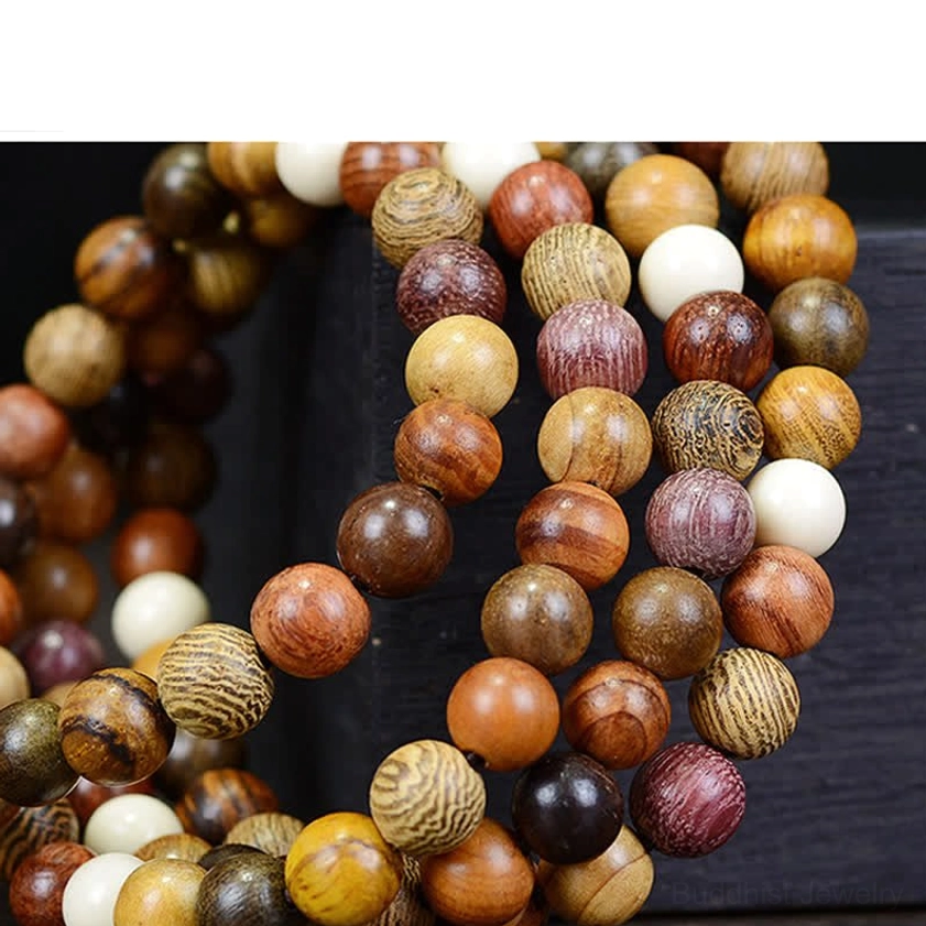 Handcrafted natural wood mala beads showing individual bead variations and natural wood grain texture, close-up composition