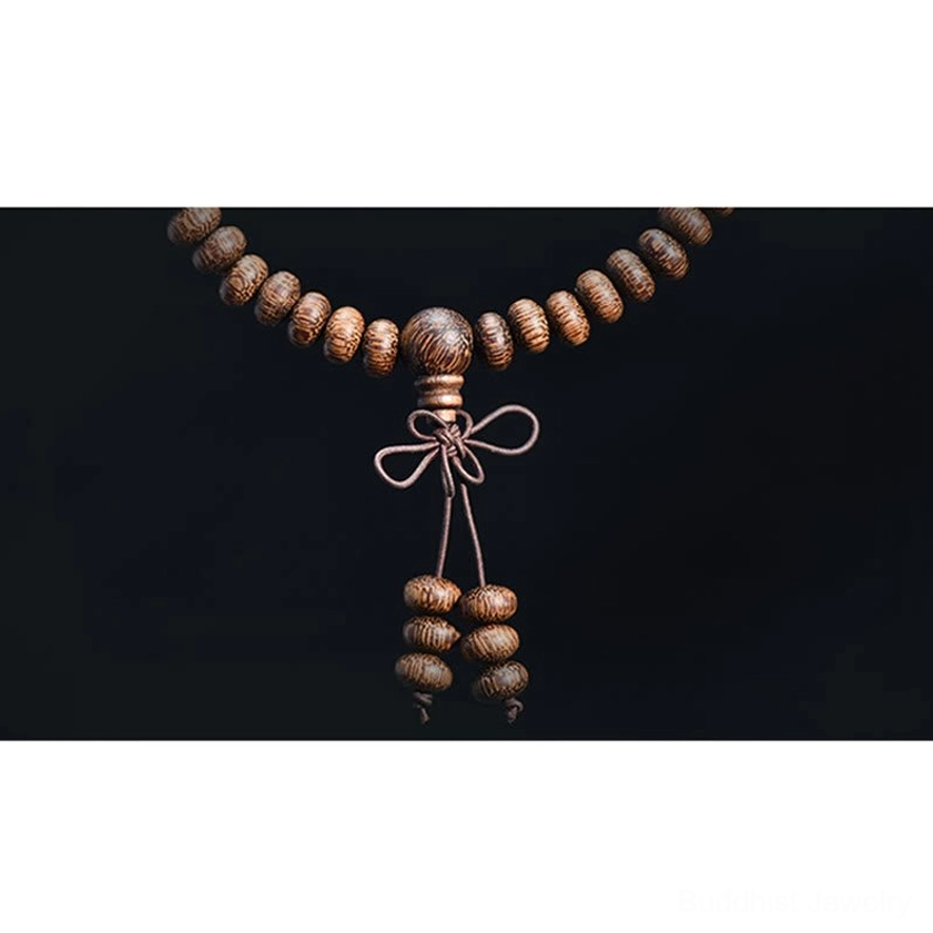 Textured natural wood mala beads showing grain patterns and organic surface texture for meditation practice