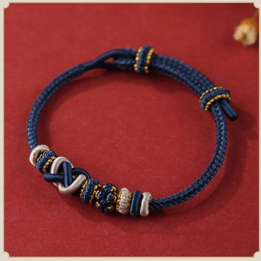 Navy blue and gold peace knot Buddhist bracelet flat lay - handcrafted for wisdom healing and spiritual serenity
