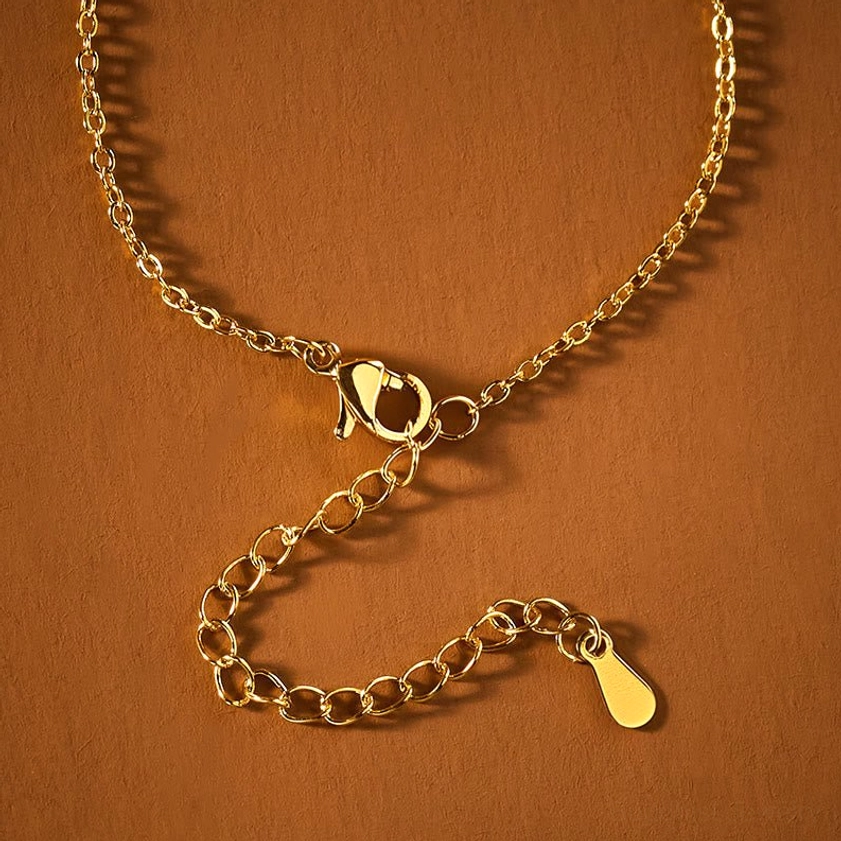 Gold-plated curb chain with lobster clasp and adjustable extension, necklace assembly components showing craftsmanship quality