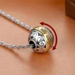 Nine-character mantra rotatable copper amulet pendant with twisted metal rope chain, close-up side view showing two-tone engraved design