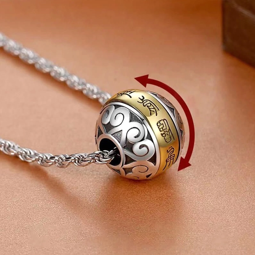 Nine-character mantra rotatable copper amulet pendant with twisted metal rope chain, close-up side view showing two-tone engraved design