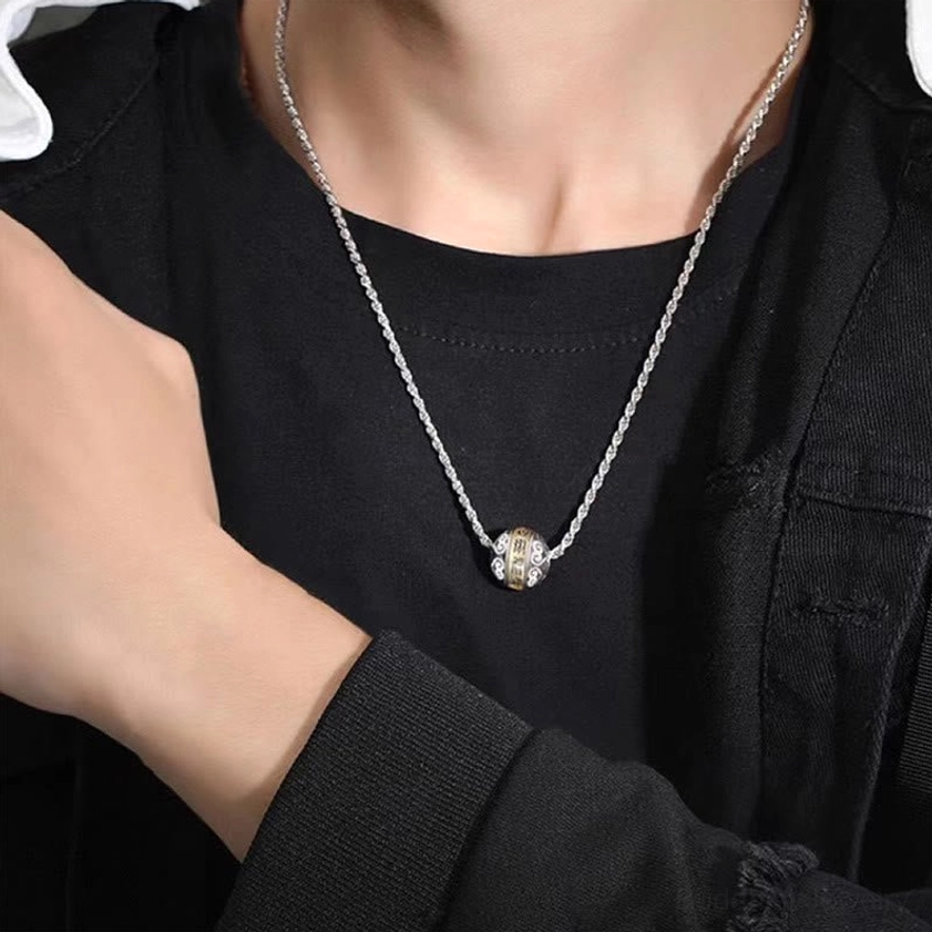Nine-character mantra protection necklace worn on chest with casual black top, daily wear lifestyle photography showing spiritual jewelry in action