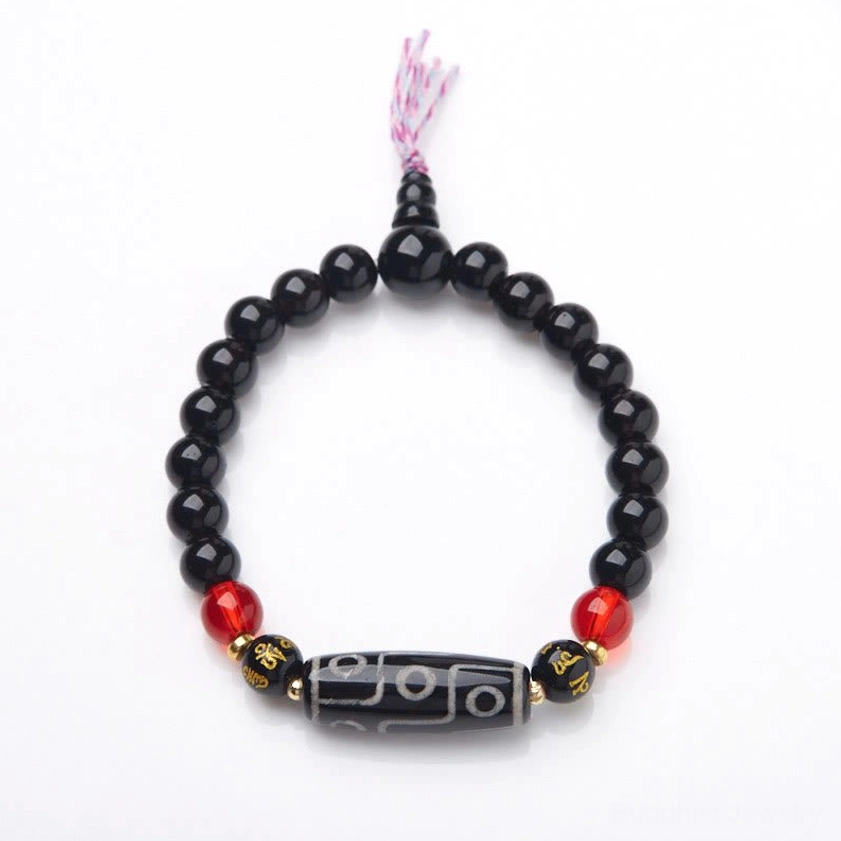 Nine-eye Dzi bead black onyx Buddhist bracelet overhead view showing complete bead arrangement and sacred symbols
