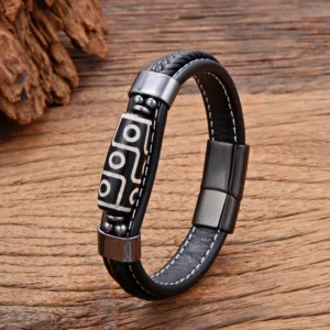 Nine-Eye Dzi bead leather bracelet with gun-black magnetic buckle and black leather strap, featuring traditional Tibetan agate bead on wooden table