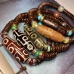 collection of handmade nine-eye dzi bead bracelets in multiple colors featuring agate beads with traditional eye patterns and natural gemstone accents