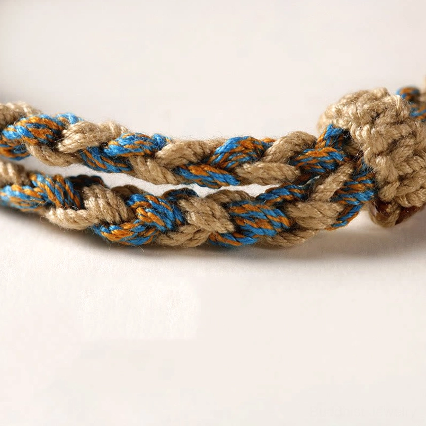 Nine-eye Dzi bead Buddhist protection bracelet full product view with handmade braided string and spiritual symbolism