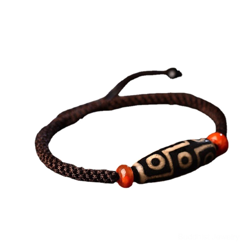Minimalist Nine-Eye Dzi Bead bracelet with braided cord and adjustable drawstring closure on pure black background