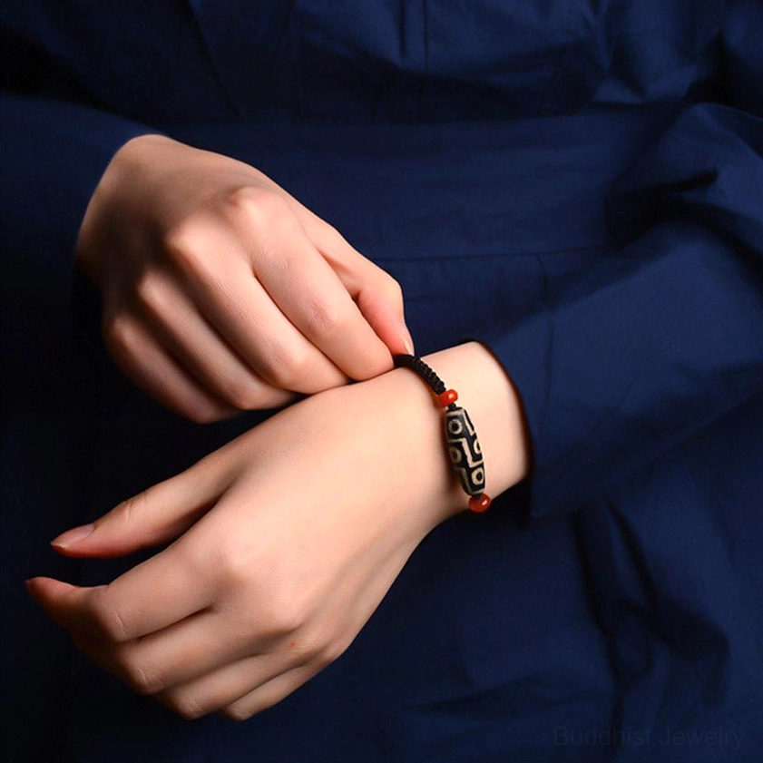 Nine-Eye Dzi Bead bracelet worn on human wrist showing comfortable fit for daily wear