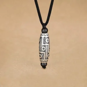 Nine-eye dzi bead copper pendant necklace front view showing intricate engraved patterns and silver-black finish